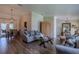 Bright living room featuring wood-look floors and seamless flow to the dining area at 817 Eagle Ln, Apollo Beach, FL 33572