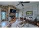Comfortable living room with stone fireplace, wood floors, and ample seating with plenty of natural lighting at 817 Eagle Ln, Apollo Beach, FL 33572