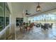 Inviting screened-in lanai with travertine flooring, stylish furnishings, and picturesque water views at 817 Eagle Ln, Apollo Beach, FL 33572
