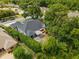 A home with a backyard and patio, surrounded by tall hedges in a quiet neighborhood at 8401 Ashford Pl, Trinity, FL 34655