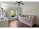 Comfortable bedroom with wood floors, a daybed, and a window offering a view of the outdoors at 8401 Ashford Pl, Trinity, FL 34655