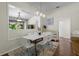 Bright dining room featuring a modern light fixture and adjacent outdoor views at 8401 Ashford Pl, Trinity, FL 34655