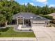 Well-maintained home features a manicured lawn, stylish landscaping, and a welcoming two-car garage at 8401 Ashford Pl, Trinity, FL 34655