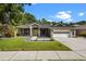 Inviting single-story home with a well-kept lawn, tasteful landscaping, and an attached two-car garage at 8401 Ashford Pl, Trinity, FL 34655