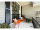 Inviting front porch featuring cozy seating, decorative plants, and charming exterior details at 8401 Ashford Pl, Trinity, FL 34655