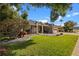 Charming single-story home featuring a well-manicured lawn, decorative rock garden, and inviting front porch at 8401 Ashford Pl, Trinity, FL 34655