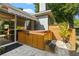 Backyard hot tub with privacy fence and steps for easy access, adjacent to the home's exterior at 8401 Ashford Pl, Trinity, FL 34655