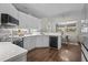 Stylish kitchen featuring white cabinets, modern appliances, and an adjacent dining area at 8401 Ashford Pl, Trinity, FL 34655
