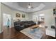 Comfortable living room featuring coffered ceilings, a large sofa, and an open layout at 8401 Ashford Pl, Trinity, FL 34655