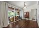 Cozy living room with hardwood floors, glass doors to an outdoor patio, and lots of natural light at 8401 Ashford Pl, Trinity, FL 34655