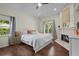 Main bedroom featuring a cozy fireplace, large windows, and hardwood flooring at 8401 Ashford Pl, Trinity, FL 34655
