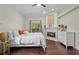 Cozy main bedroom with fireplace, large window, and neutral decor at 8401 Ashford Pl, Trinity, FL 34655