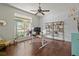 Bright home office with textured accent wall, large window, and ceiling fan at 8401 Ashford Pl, Trinity, FL 34655