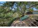 Scenic backyard with a private dock, boat, and access to a tranquil waterway, shaded by mature trees at 8517 Woodwick Ct, Tampa, FL 33615
