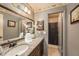 Bathroom features a vanity, mirror, granite countertop, and a view of the shower at 8517 Woodwick Ct, Tampa, FL 33615
