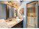 Updated bathroom with granite countertop, stylish vanity, and walk-in tub/shower combo at 8517 Woodwick Ct, Tampa, FL 33615