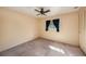 Bedroom features a ceiling fan, a window with blinds, and a closet for storage at 8517 Woodwick Ct, Tampa, FL 33615