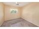 Empty bedroom with a ceiling fan, window, and carpet at 8517 Woodwick Ct, Tampa, FL 33615