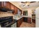 Well-equipped kitchen featuring wood cabinetry, tiled backsplash, and stainless steel appliances at 8517 Woodwick Ct, Tampa, FL 33615