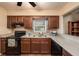 Functional kitchen with wood cabinets, tile backsplash, and modern appliances at 8517 Woodwick Ct, Tampa, FL 33615
