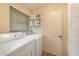 Practical laundry area with washer, dryer, and shelving for storage and convenience at 8517 Woodwick Ct, Tampa, FL 33615