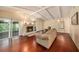 Spacious living room featuring hardwood floors, a fireplace, vaulted ceilings, and access to the outdoor patio at 8517 Woodwick Ct, Tampa, FL 33615