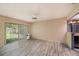A sunny living room features neutral walls, and floors, and backyard access at 8517 Woodwick Ct, Tampa, FL 33615