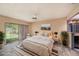 A beautifully staged primary bedroom features backyard access and neutral decor at 8517 Woodwick Ct, Tampa, FL 33615