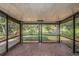 Spacious screened-in porch with brick flooring and view of the backyard at 8517 Woodwick Ct, Tampa, FL 33615