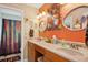Bright bathroom featuring double sinks, colorful walls, and a walk-in shower at 9018 39Th N Ln # 5, Pinellas Park, FL 33782