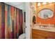 Bright bathroom featuring a walk-in shower, colorful walls, and plenty of natural light at 9018 39Th N Ln # 5, Pinellas Park, FL 33782