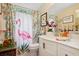 Bright bathroom featuring neutral walls, modern lights, and a pink flamingo themed shower curtain at 9018 39Th N Ln # 5, Pinellas Park, FL 33782