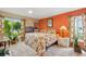 Bright bedroom featuring light wood floors, colorful walls and curtains, and plenty of natural light at 9018 39Th N Ln # 5, Pinellas Park, FL 33782
