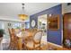 Traditional dining room boasts wood table, ornate chandelier, and view into the kitchen and living areas at 9018 39Th N Ln # 5, Pinellas Park, FL 33782