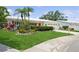 Inviting single-Gathering home with a well-kept lawn, decorative plants, and a clean, bright exterior at 9018 39Th N Ln # 5, Pinellas Park, FL 33782