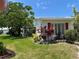Well-maintained home exterior featuring red shutters, lush landscaping, and a green lawn at 9018 39Th N Ln # 5, Pinellas Park, FL 33782