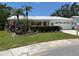 Beautiful single-story house with lush landscaping, white roof, and a cozy, inviting front yard at 9018 39Th N Ln # 5, Pinellas Park, FL 33782