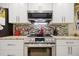 Updated kitchen features stainless steel appliances, granite countertops, and tile backsplash at 9018 39Th N Ln # 5, Pinellas Park, FL 33782