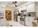 Bright kitchen featuring white cabinetry, stainless steel appliances, and a view into the dining area at 9018 39Th N Ln # 5, Pinellas Park, FL 33782