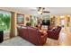 Inviting living room featuring stylish leather furniture, neutral walls, and plenty of natural light at 9018 39Th N Ln # 5, Pinellas Park, FL 33782