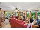 Spacious living room featuring comfortable seating, natural light, and access to an enclosed patio at 9018 39Th N Ln # 5, Pinellas Park, FL 33782