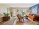 Bright living room boasting hardwood floors, colorful decor, and a comfortable seating arrangement at 9018 39Th N Ln # 5, Pinellas Park, FL 33782