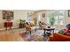 Cozy living room features hardwood floors, colorful artwork, and comfortable, patterned seating at 9018 39Th N Ln # 5, Pinellas Park, FL 33782