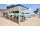 Community pool area features shaded tables and chairs with ample lounge seating by the pool at 9018 39Th N Ln # 5, Pinellas Park, FL 33782