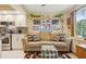 Living area showing comfortable sofa with accent pillows, built-in shelves, and an area rug at 9018 39Th N Ln # 5, Pinellas Park, FL 33782