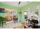 Bright sunroom features sliding glass doors, tile flooring, and comfortable furnishings at 9018 39Th N Ln # 5, Pinellas Park, FL 33782