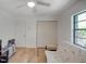 Bedroom with wood-look floors and a window view at 934 Lucas Ln, Oldsmar, FL 34677