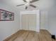 Bright bedroom featuring wood-look floors and a ceiling fan at 934 Lucas Ln, Oldsmar, FL 34677