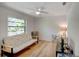 Bedroom with a light ceiling fan and a large window at 934 Lucas Ln, Oldsmar, FL 34677