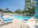 Community pool with lounge chairs, umbrella and table, ideal for relaxation and enjoying sunny days at 934 Lucas Ln, Oldsmar, FL 34677